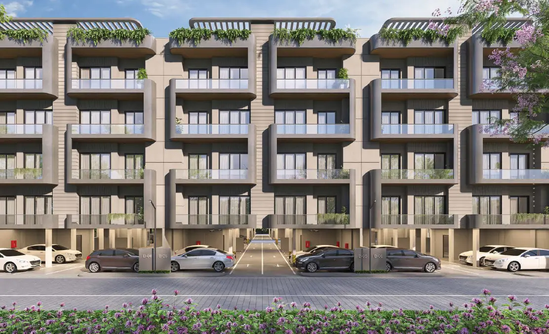 Modern and spacious lobby with marble floors, reception desk, warm lighting, and people inside